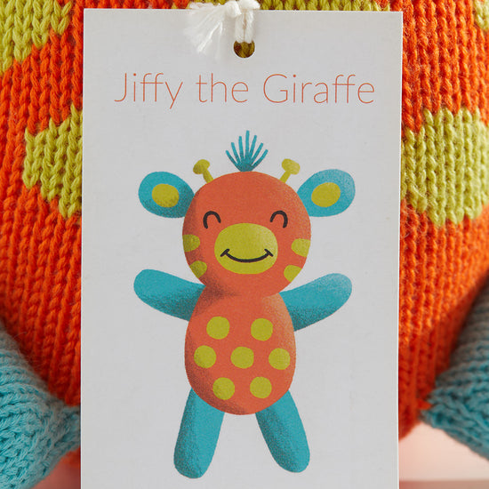 A tag displays an illustration of Jiffy the Giraffe, a colorful knitted toy, with the website thejoobles.com printed below.