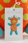 A tag displays an illustration of Jiffy the Giraffe, a colorful knitted toy, with the website thejoobles.com printed below.