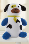 A knitted plush dog toy with blue limbs, black spots, a yellow collar, and a brown snout, sitting on a white surface.
