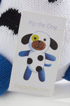A close-up of a tag showing a cartoon dog named Pip the Dog with blue legs, black spots, and a link to the website thejoobles.com.